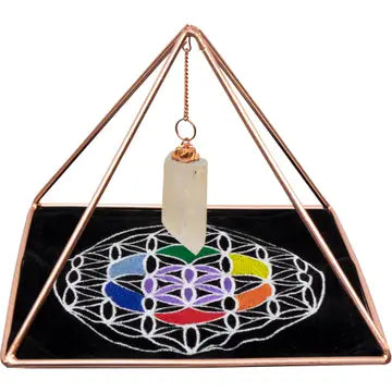 Pirâmide de cobre alinhada sobre uma mesa para meditação e cura.