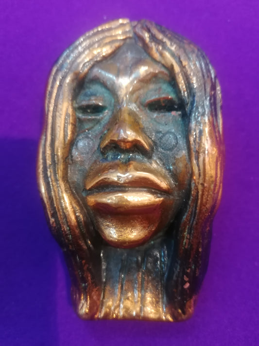 Máscara africana vintage em latão estilo Baule Mblo com acabamento bimetálico dourado e escuro de 10x5cm da Série B.