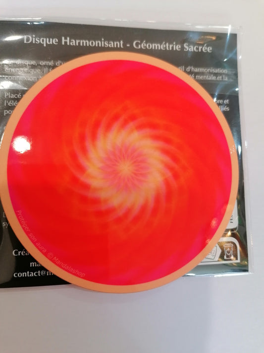 Disco de geometria sagrada com mandala laranja e vórtice central para proteção da aura.